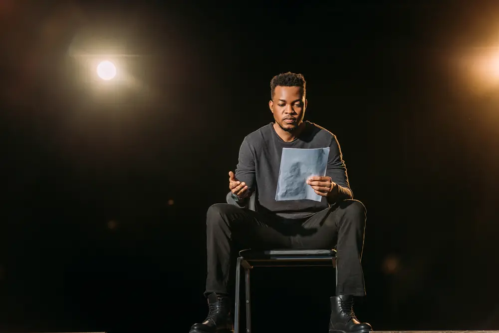 Handsome,African,American,Actor,Holding,Scenario,On,Stage,During,Rehearse