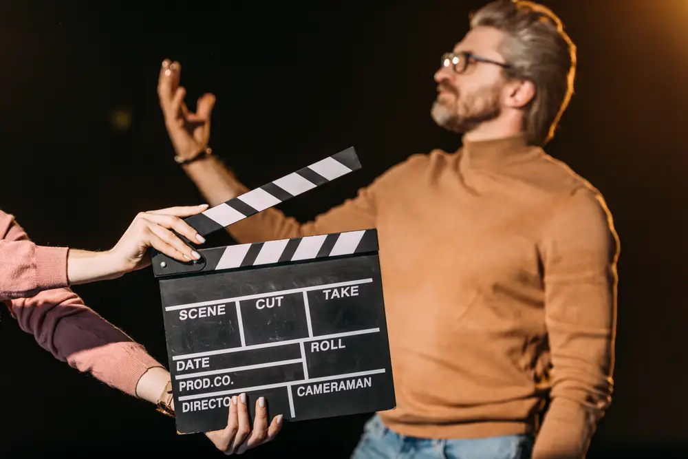 Selective,Focus,Of,Mature,Actor,Performing,Role,With,Clapboard,In